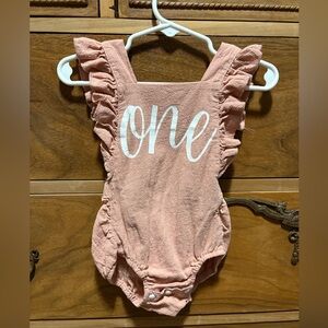 Pink ‘One’ romper